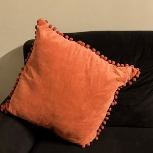 Orange tassel throw pillow